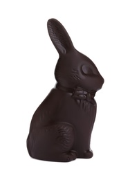 Photo of Dark chocolate bunny isolated on white. Easter celebration