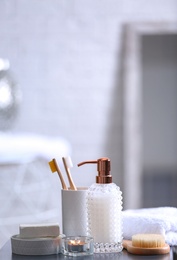 Photo of Composition with soap and toiletries on table against blurred background. Space for text