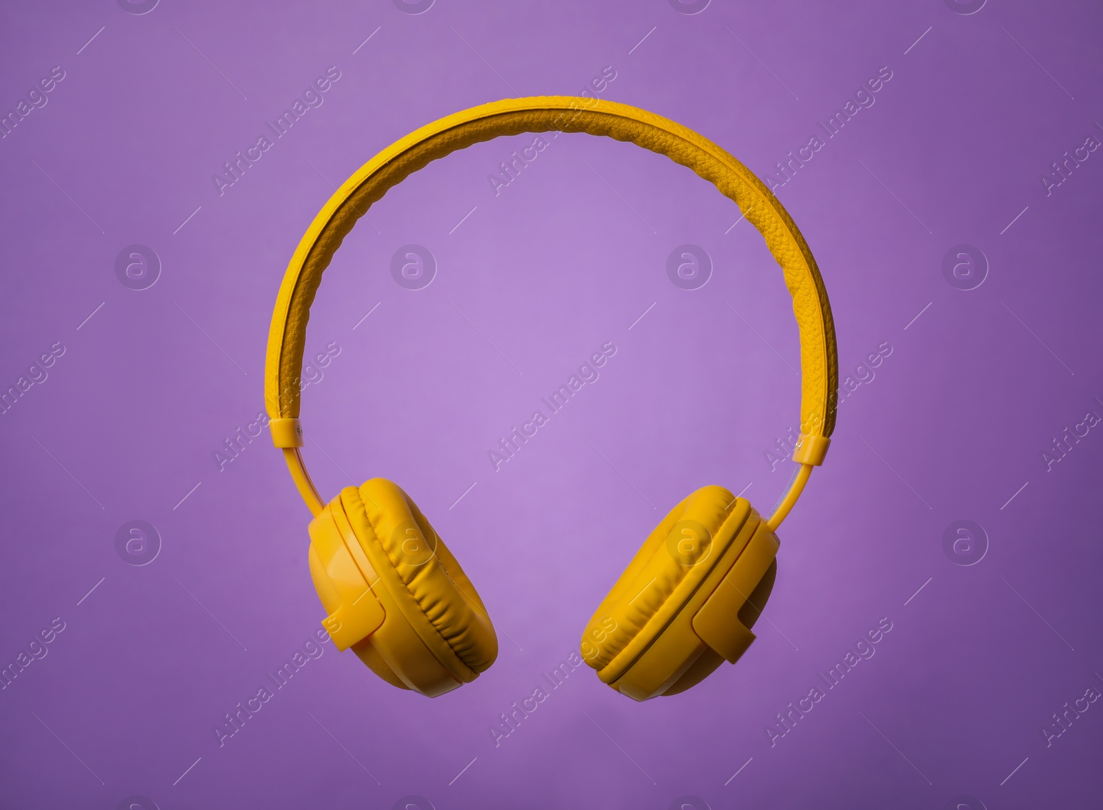 Photo of Wireless headphones with earmuffs on color background