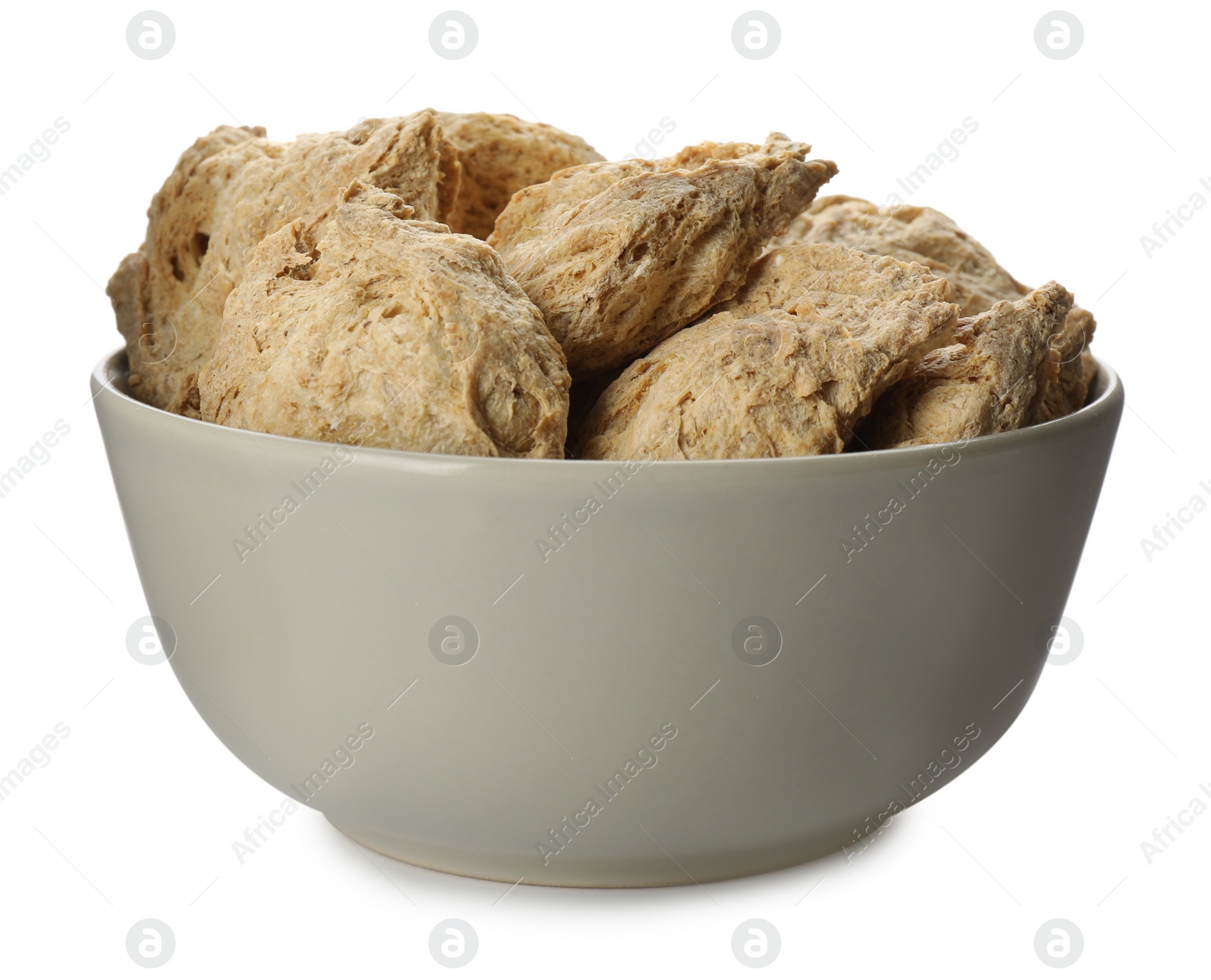 Photo of Dehydrated soy meat chunks in bowl on white background