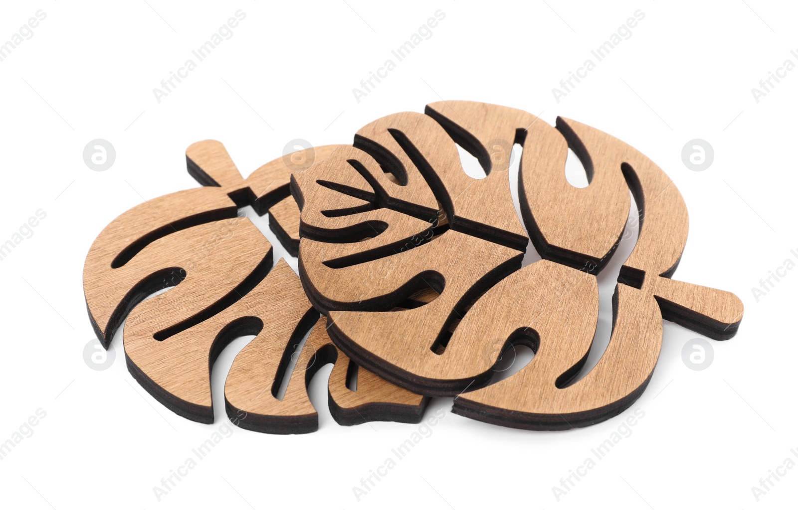 Photo of Leaf shaped wooden cup coasters on white background