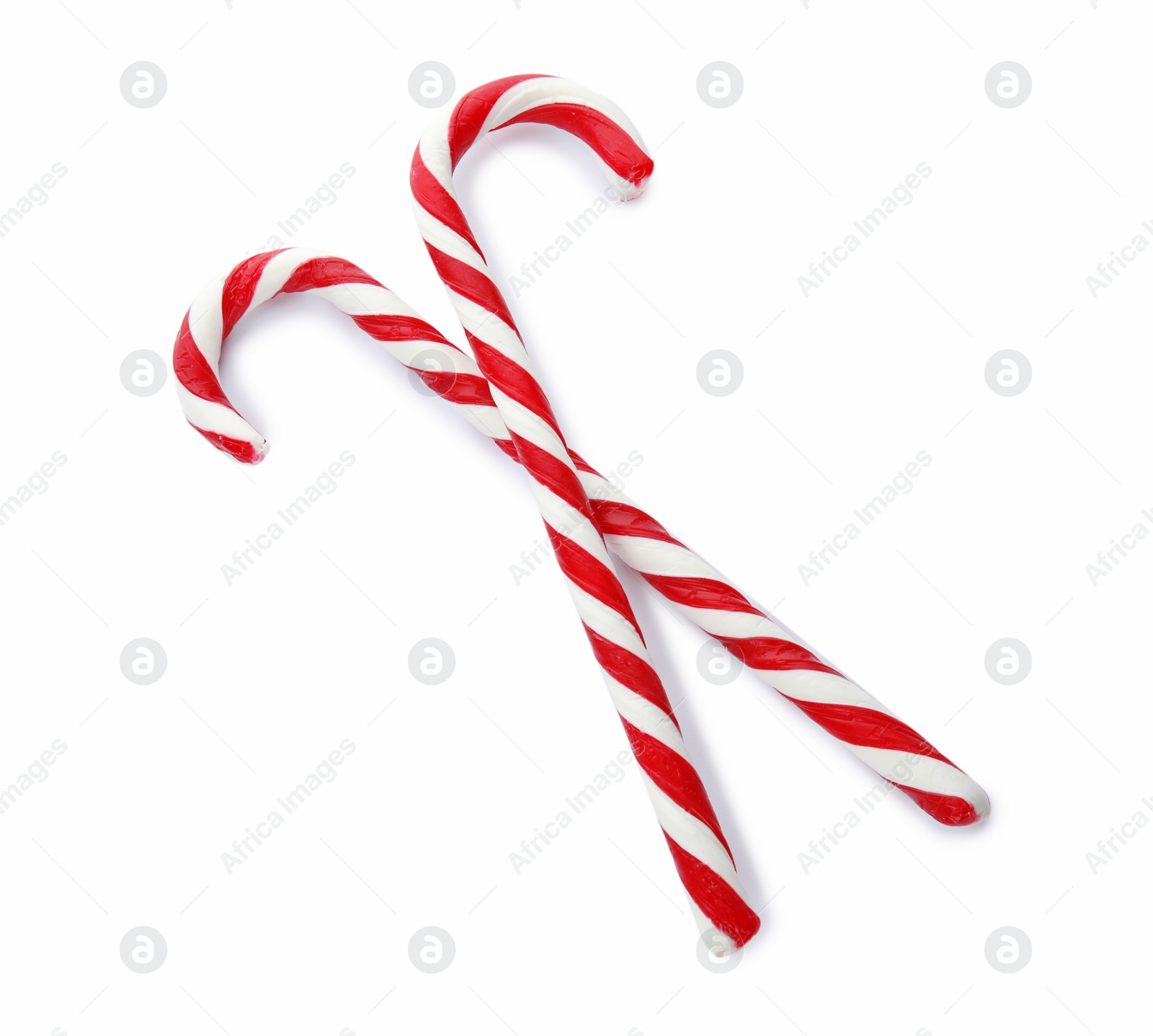 Photo of Tasty candy canes on white background. Festive treat