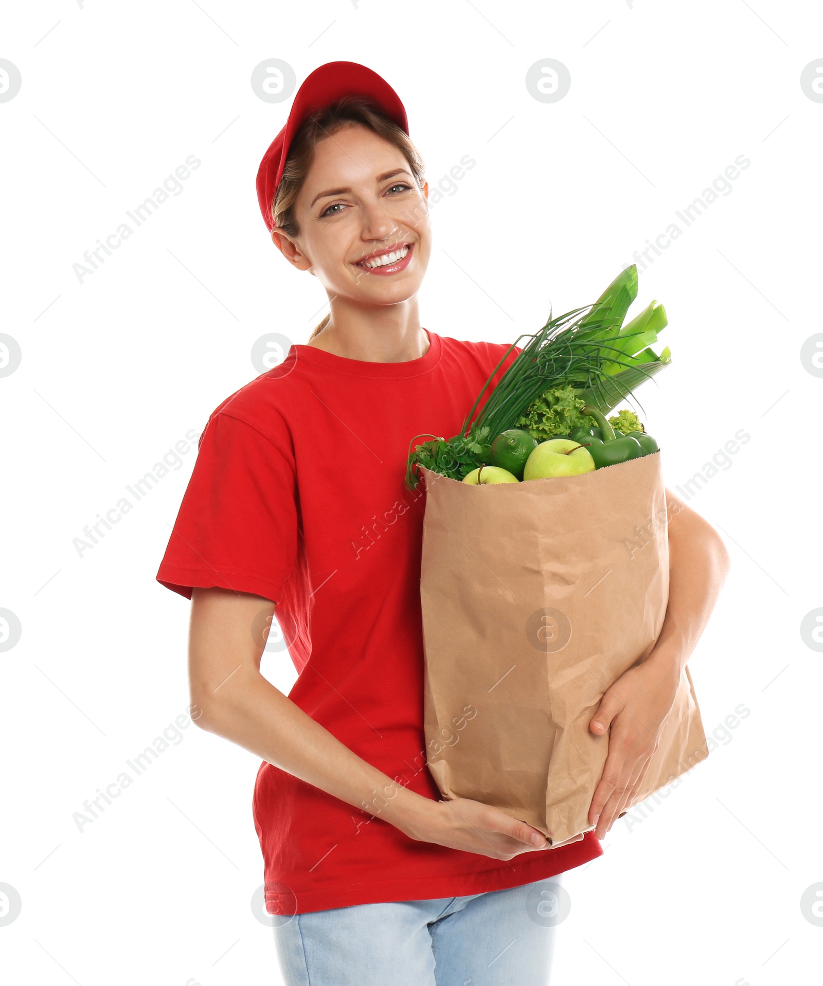 Photo of Delivery woman with bag of fresh vegetables on white background