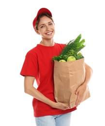 Photo of Delivery woman with bag of fresh vegetables on white background