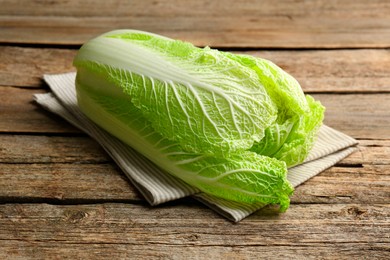 Photo of Fresh ripe Chinese cabbage on wooden table