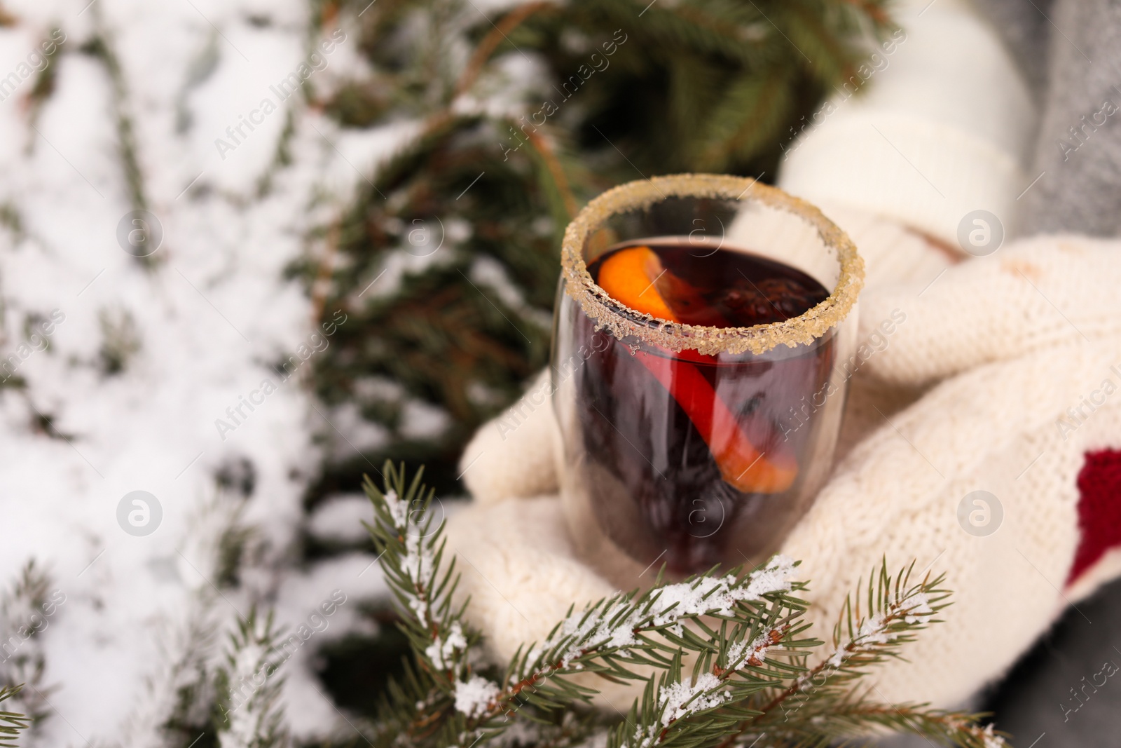 Photo of Woman with tasty mulled wine outdoors, closeup