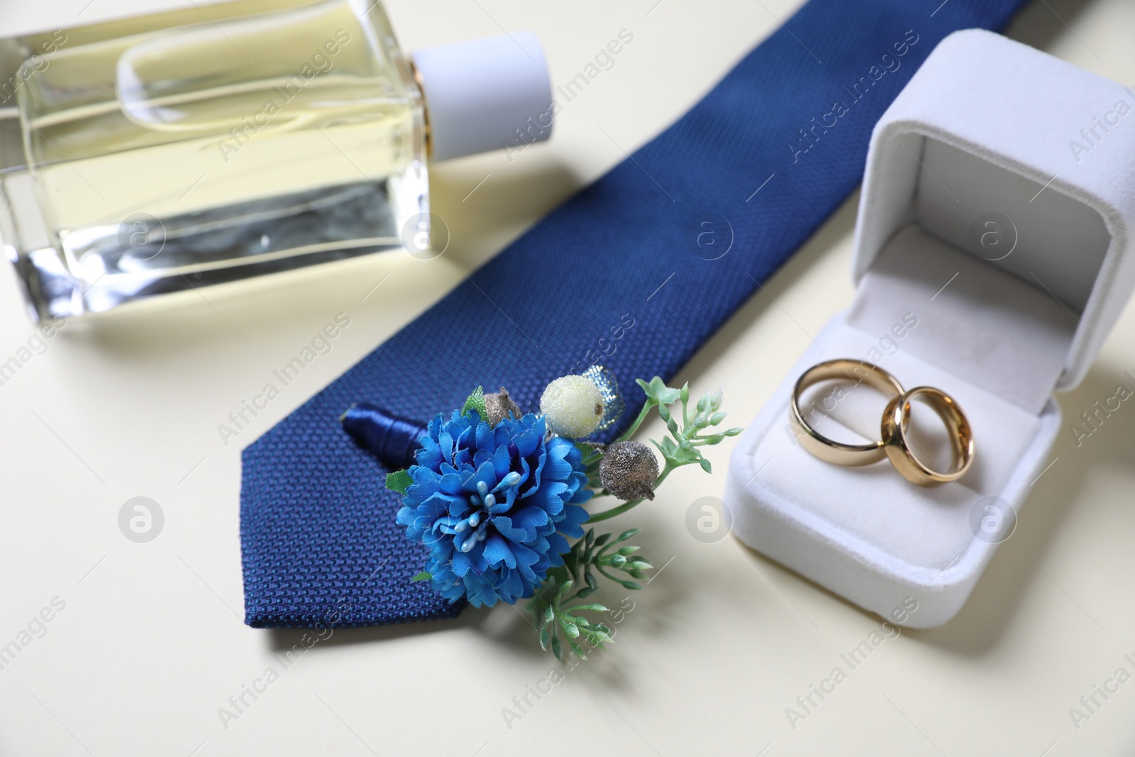 Photo of Wedding stuff. Composition with stylish boutonniere on light background, closeup