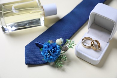 Photo of Wedding stuff. Composition with stylish boutonniere on light background, closeup