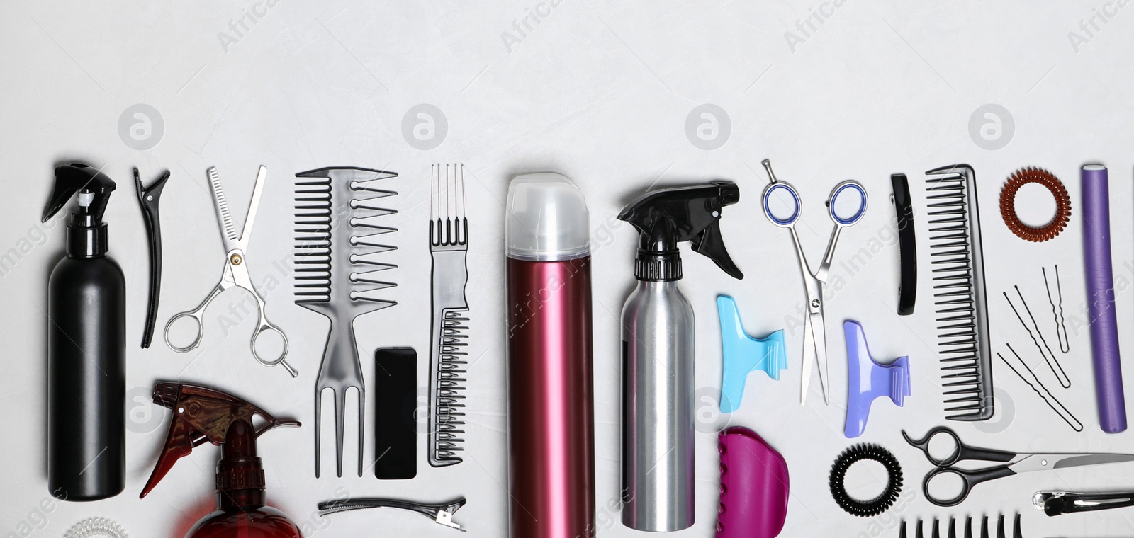 Image of Set of professional hairdresser's tools on light background, flat lay. Banner design