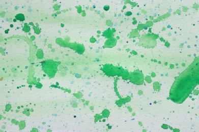 Photo of Abstract watercolor painting with green blots as background, top view
