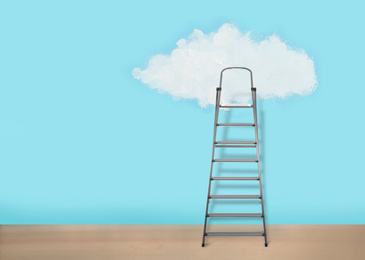 Image of Metal stepladder near light blue wall with painted cloud. Conceptual design 