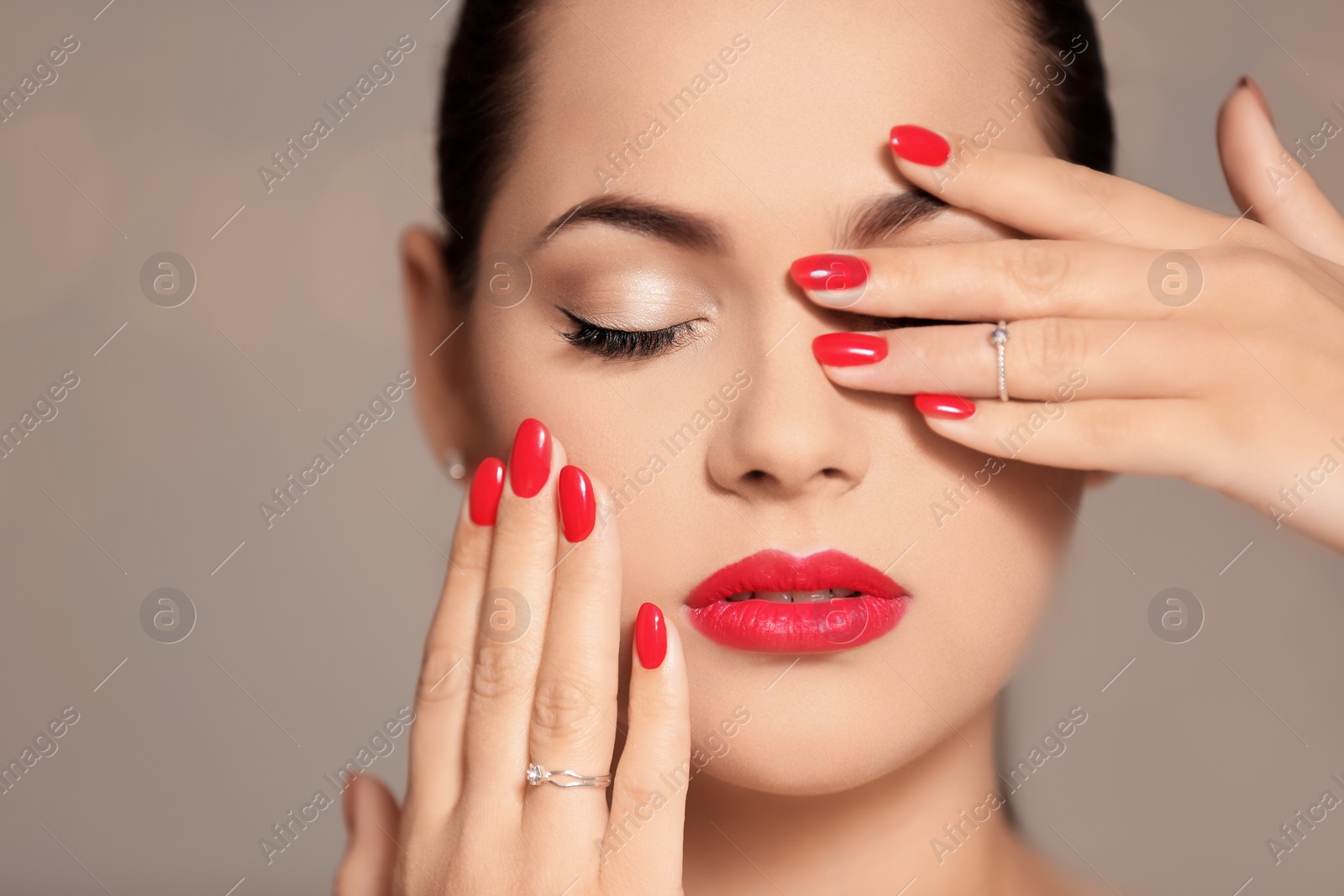 Photo of Beautiful young woman with bright manicure on color background, closeup. Nail polish trends