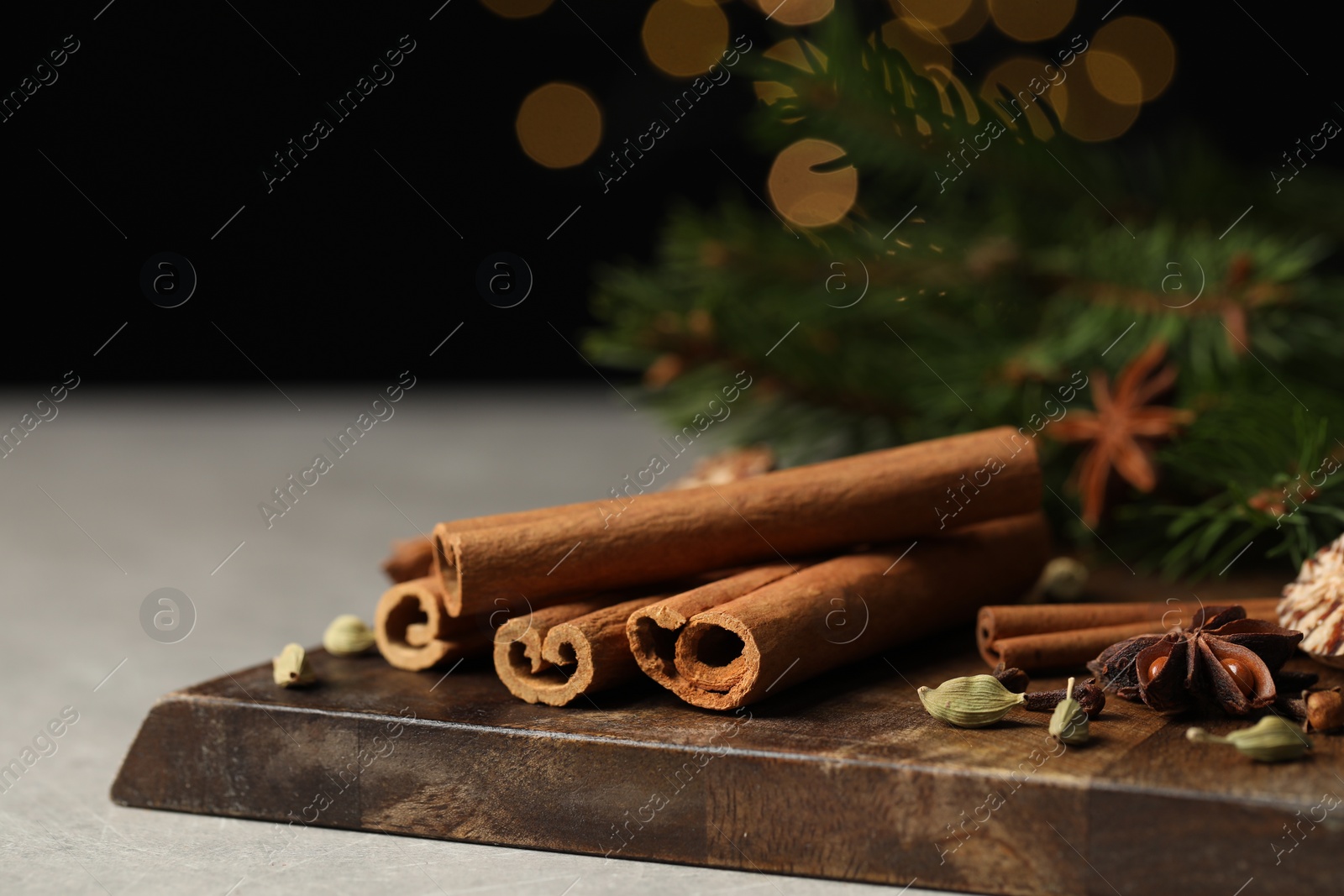 Photo of Board with different aromatic spices on light table, closeup. Space for text