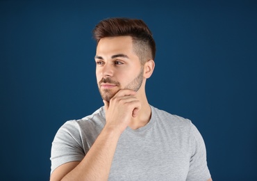 Portrait of handsome man on color background