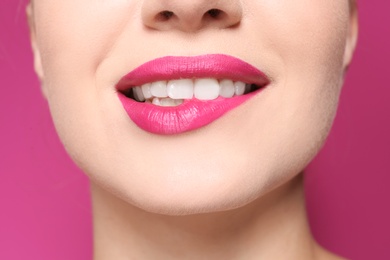 Photo of Beautiful young woman with perfect lips makeup on color background, closeup