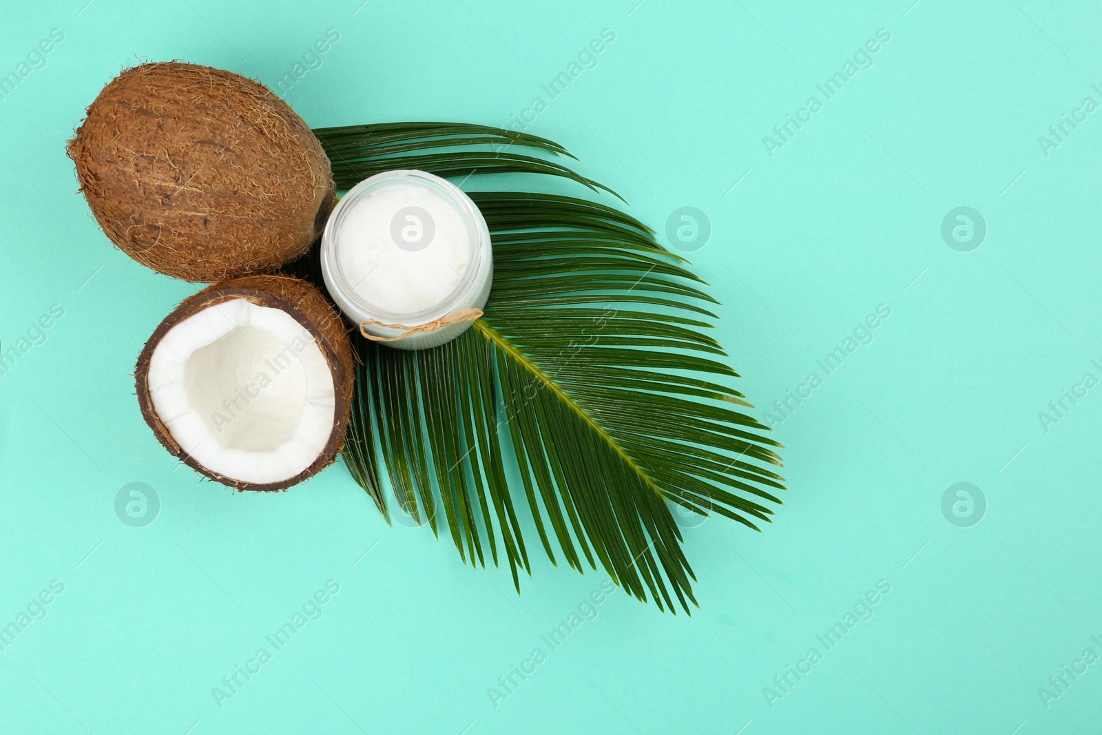 Photo of Flat lay composition with organic coconut oil on turquoise background. Healthy cooking