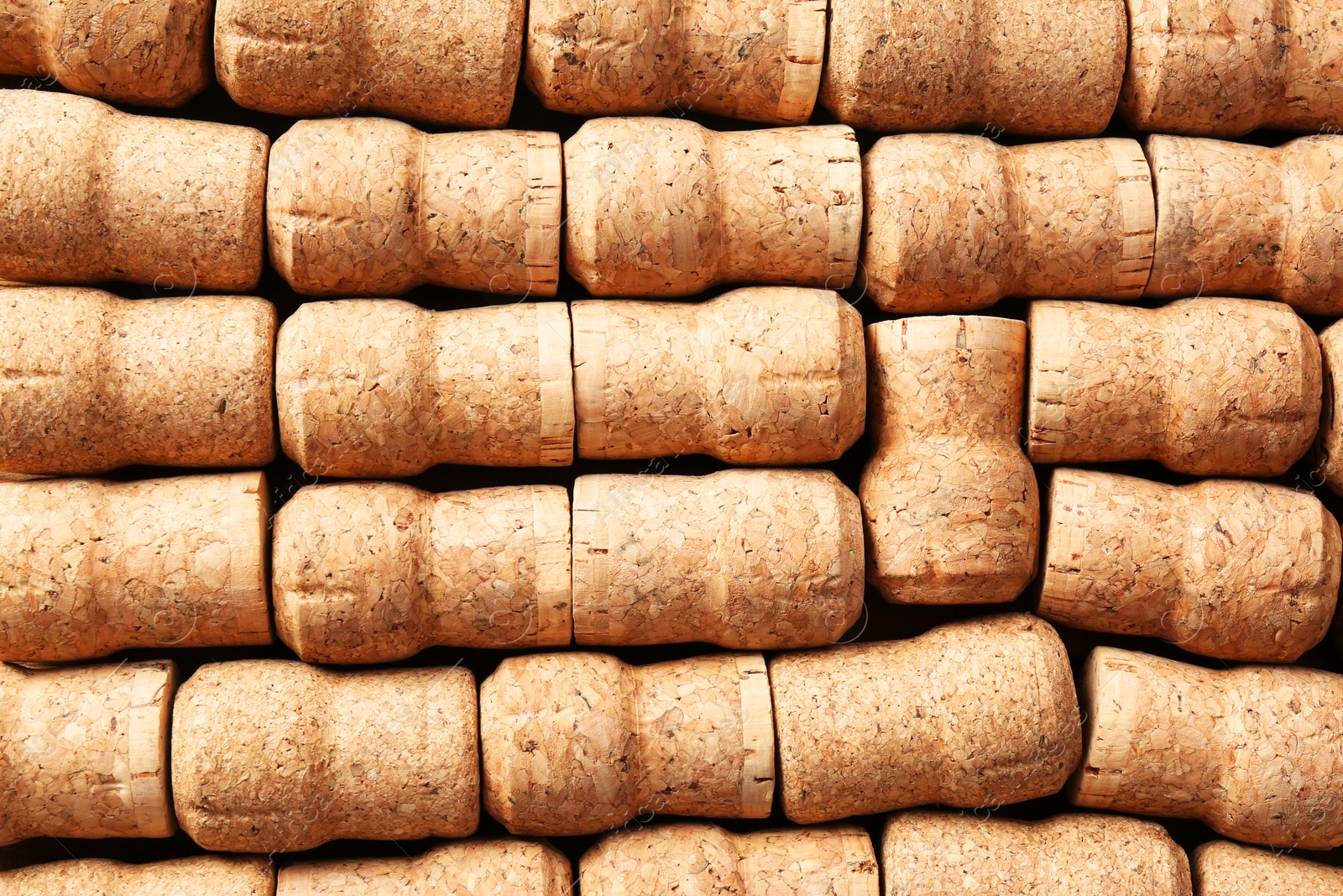 Photo of Many corks of wine bottles as background, top view