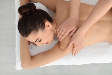 Young woman receiving massage in spa salon