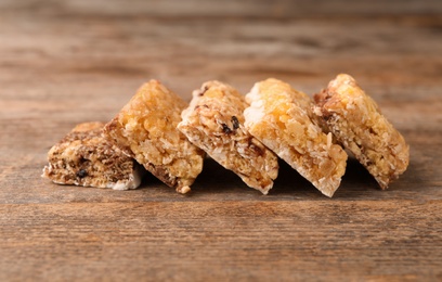 Photo of Tasty protein bars on wooden table. Healthy snack