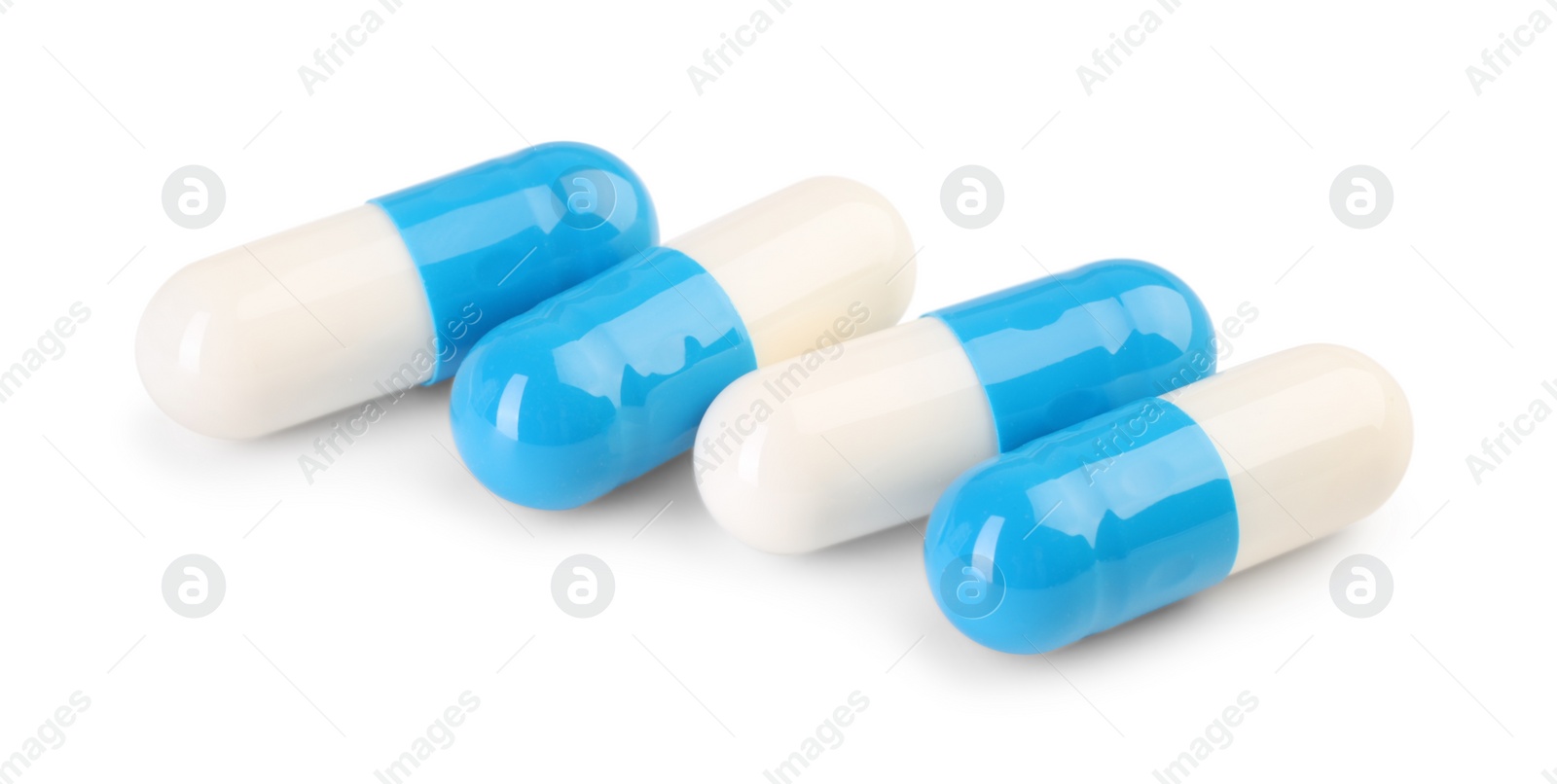 Photo of Antibiotic pills isolated on white. Medicinal treatment