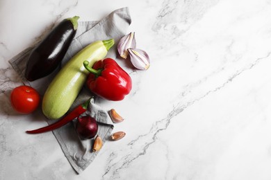 Photo of Fresh vegetables for ratatouille on white marble table, flat lay. Space for text