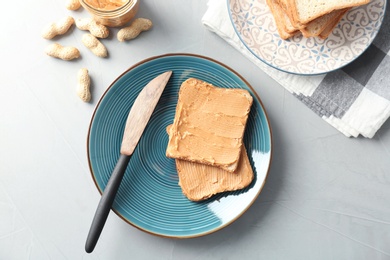 Photo of Tasty toasts with peanut butter on plate