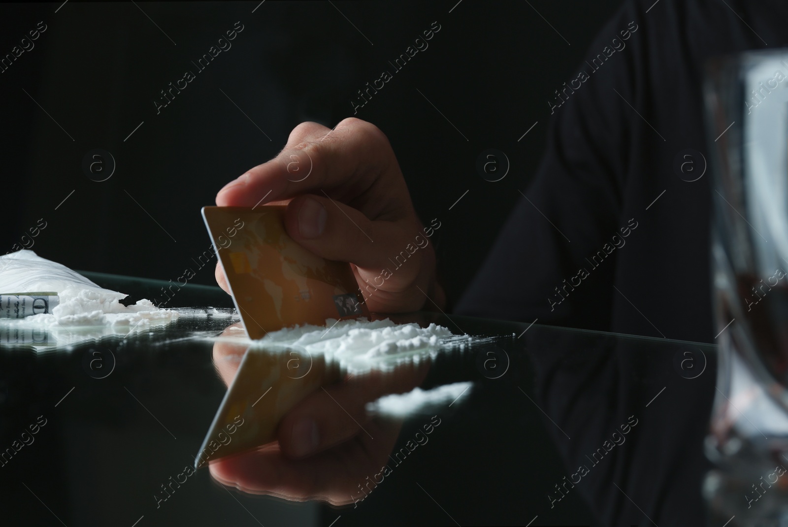 Photo of Drug addict taking cocaine at table, closeup view