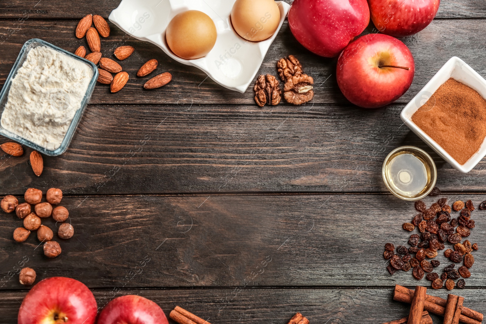 Photo of Flat lay composition with ingredients for dough and products on wooden background