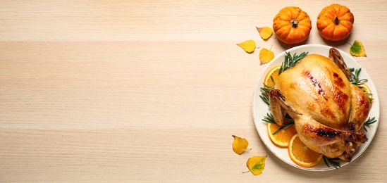 Happy Thanksgiving Day, banner design. Traditional cooked turkey and autumn decor on wooden table, flat lay with space for text