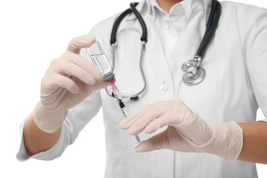 Photo of Doctor filling syringe with medication from glass vial on white background, closeup