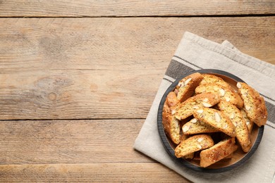 Traditional Italian almond biscuits (Cantucci) on wooden table, top view. Space for text