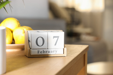 Wooden block calendar on table indoors, closeup