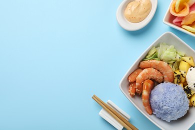 Photo of Poke bowl served on light blue background, flat lay. Space for text