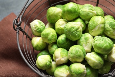 Photo of Basket with fresh Brussels sprouts on table, closeup