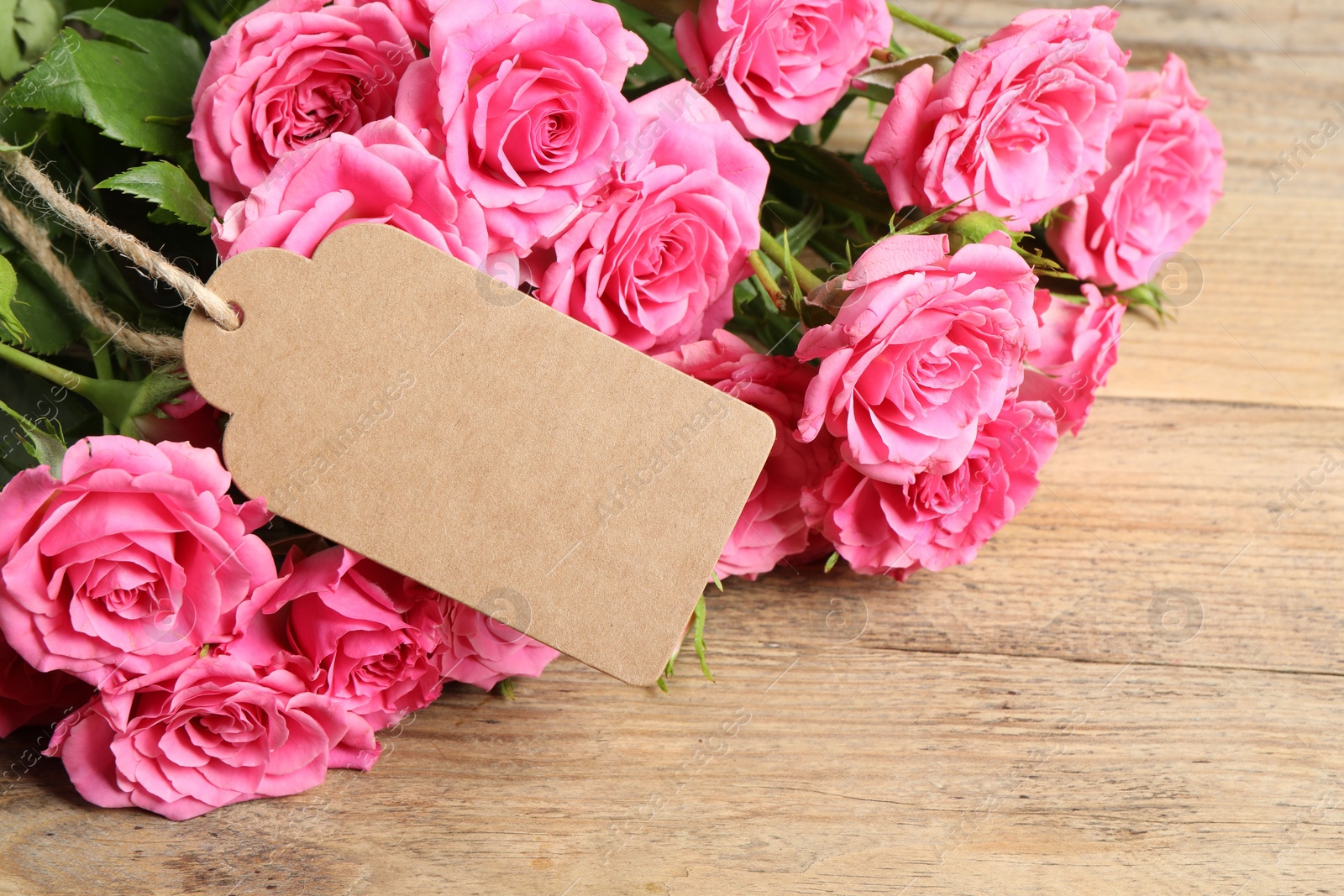 Photo of Happy Mother's Day. Beautiful flowers and blank card on wooden table