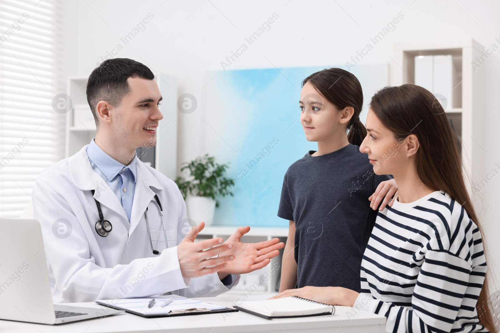 Photo of Gastroenterologist consulting woman and her daughter in clinic