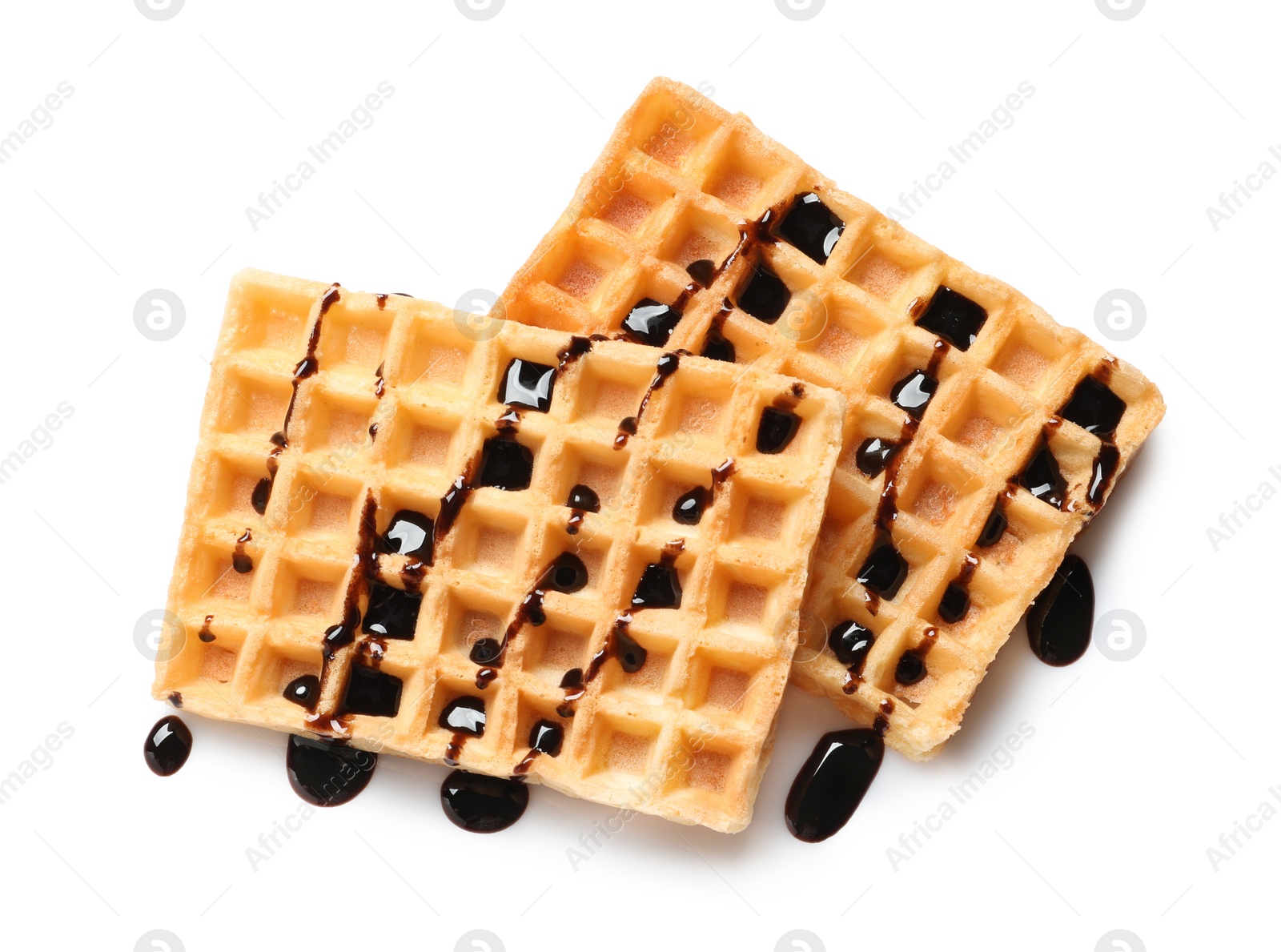 Photo of Delicious waffles with chocolate syrup on white background, top view