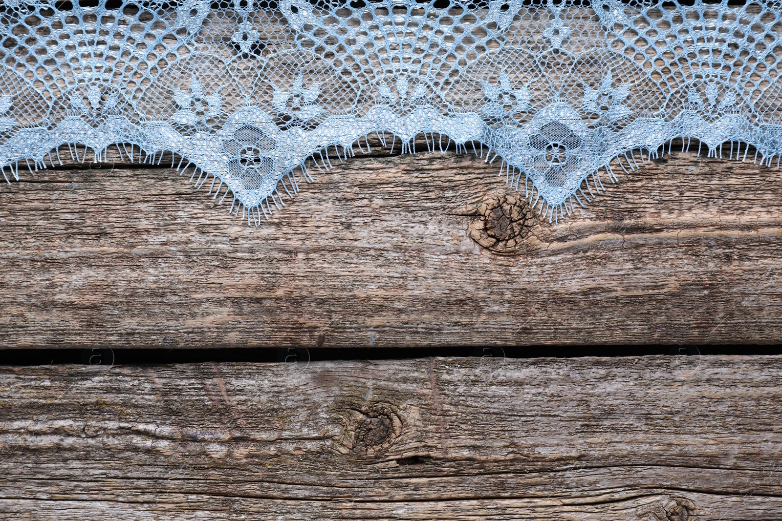 Photo of Beautiful lace on wooden table, top view. Space for text