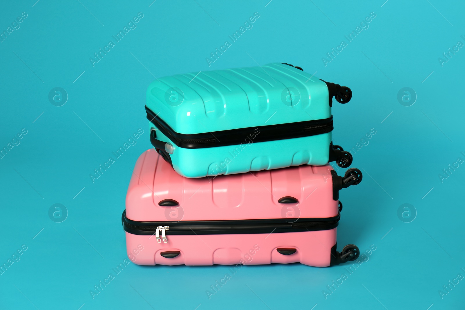 Photo of Stylish carry on suitcases on color background