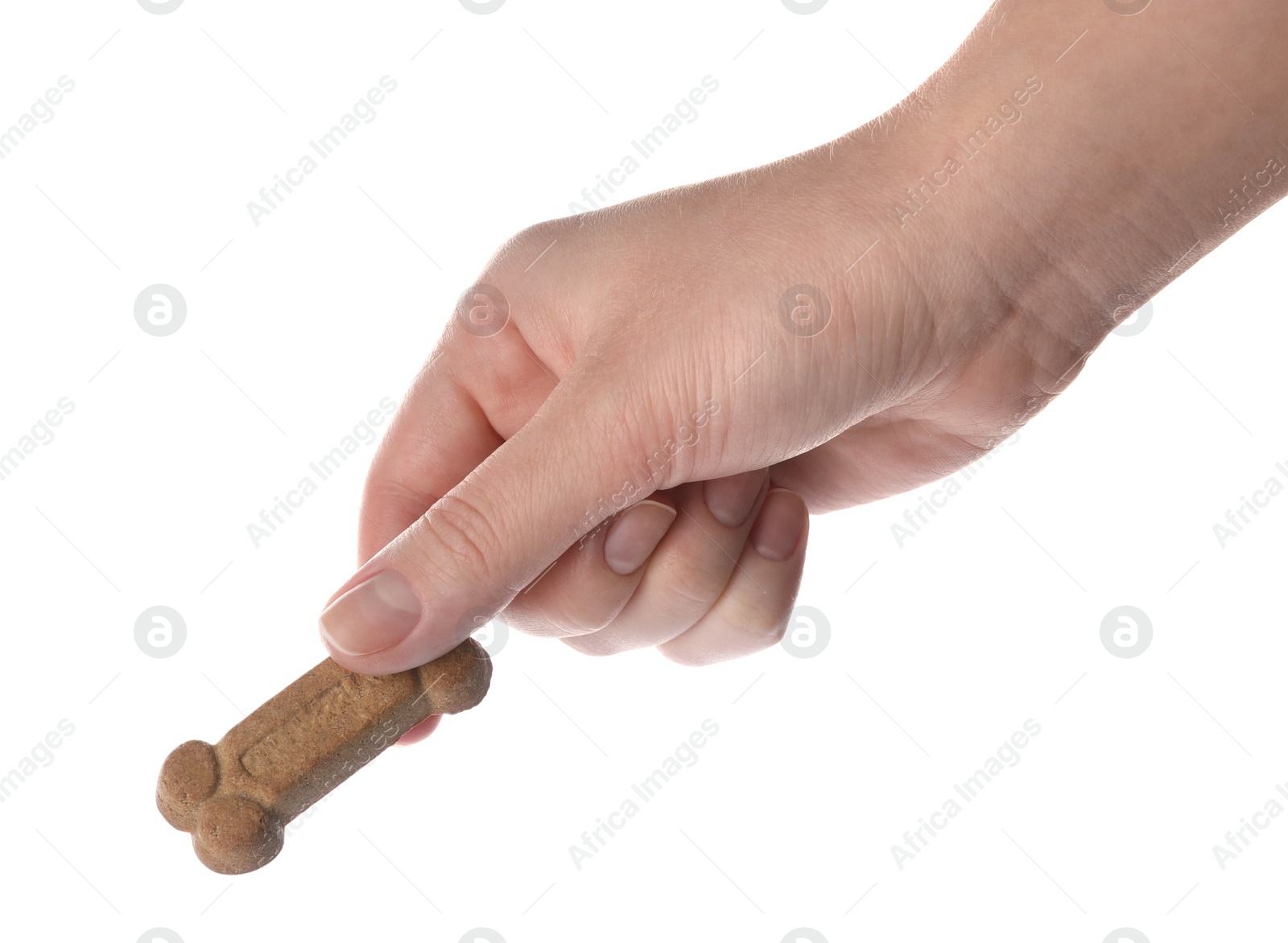 Photo of Woman holding bone shaped dog cookie on white background, closeup