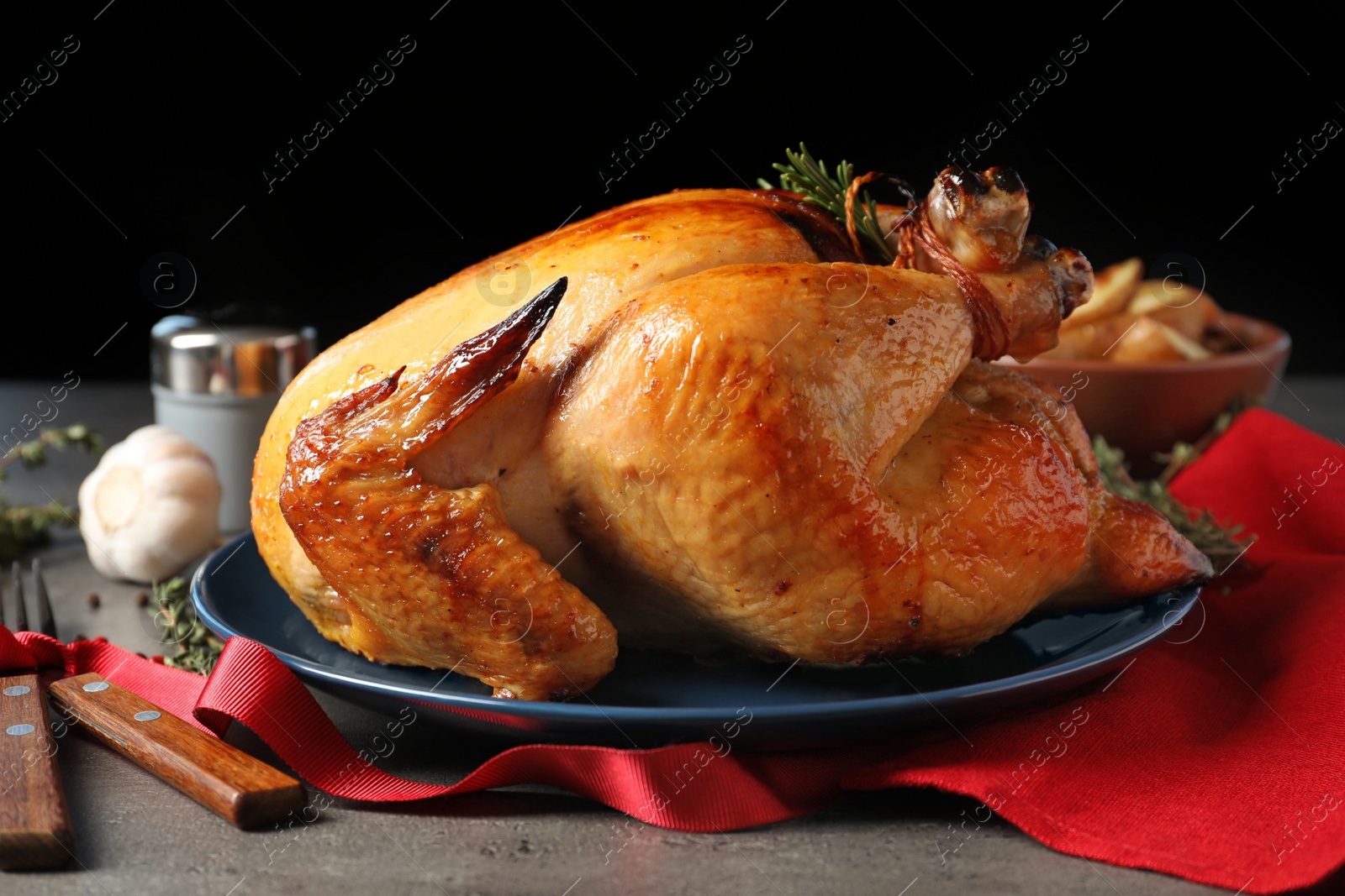 Photo of Platter of cooked turkey with rosemary served on table