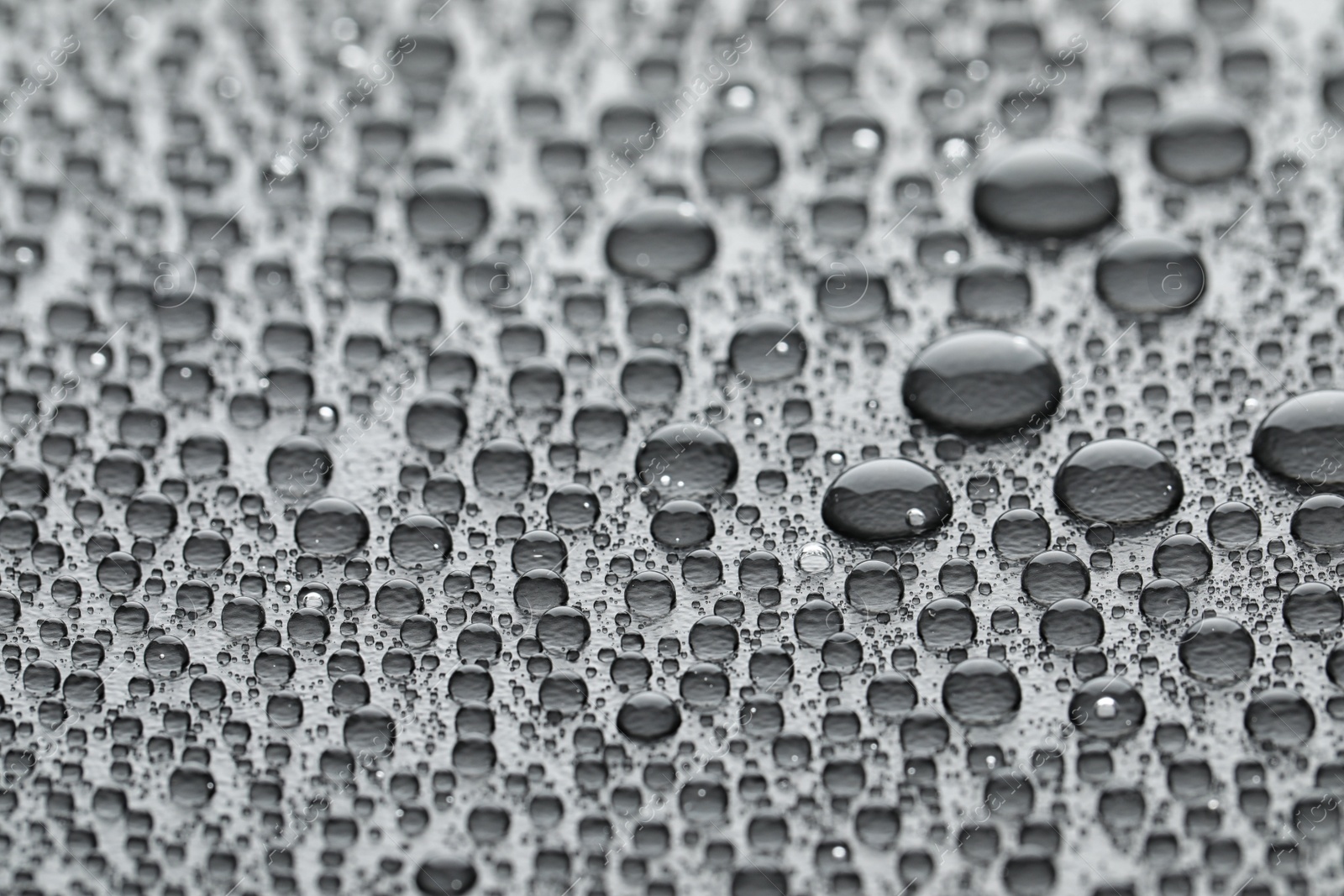 Photo of Water drops on grey background, closeup view