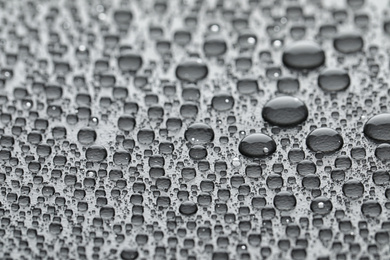 Water drops on grey background, closeup view