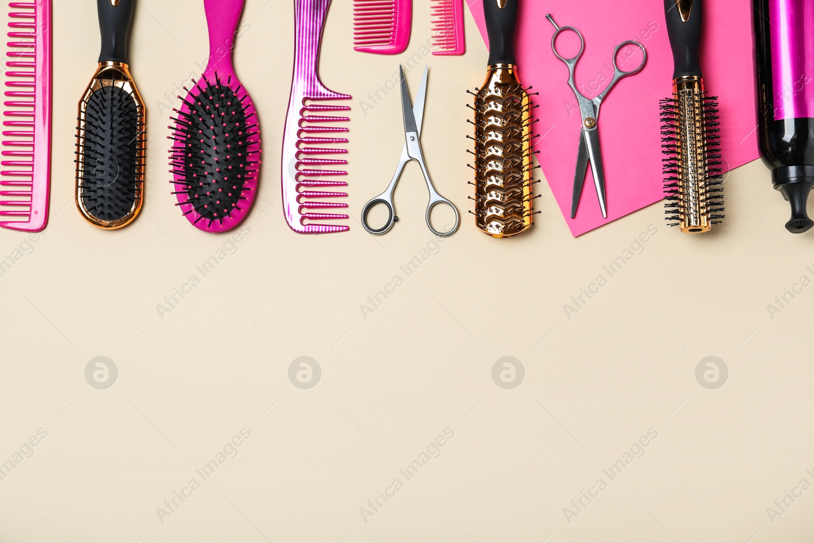 Photo of Flat lay composition of professional scissors and other hairdresser's equipment on color background, space for text. Haircut tool