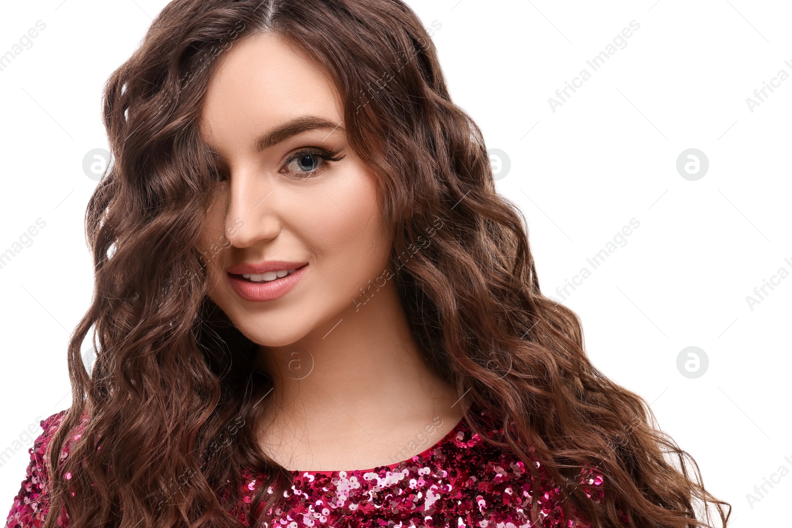 Photo of Beautiful young woman with long curly brown hair in pink sequin dress on white background