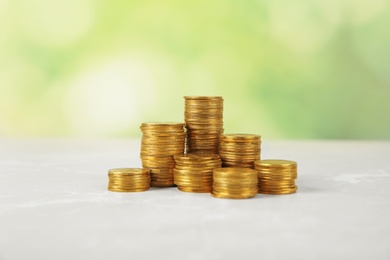 Stacks of coins on table against blurred background