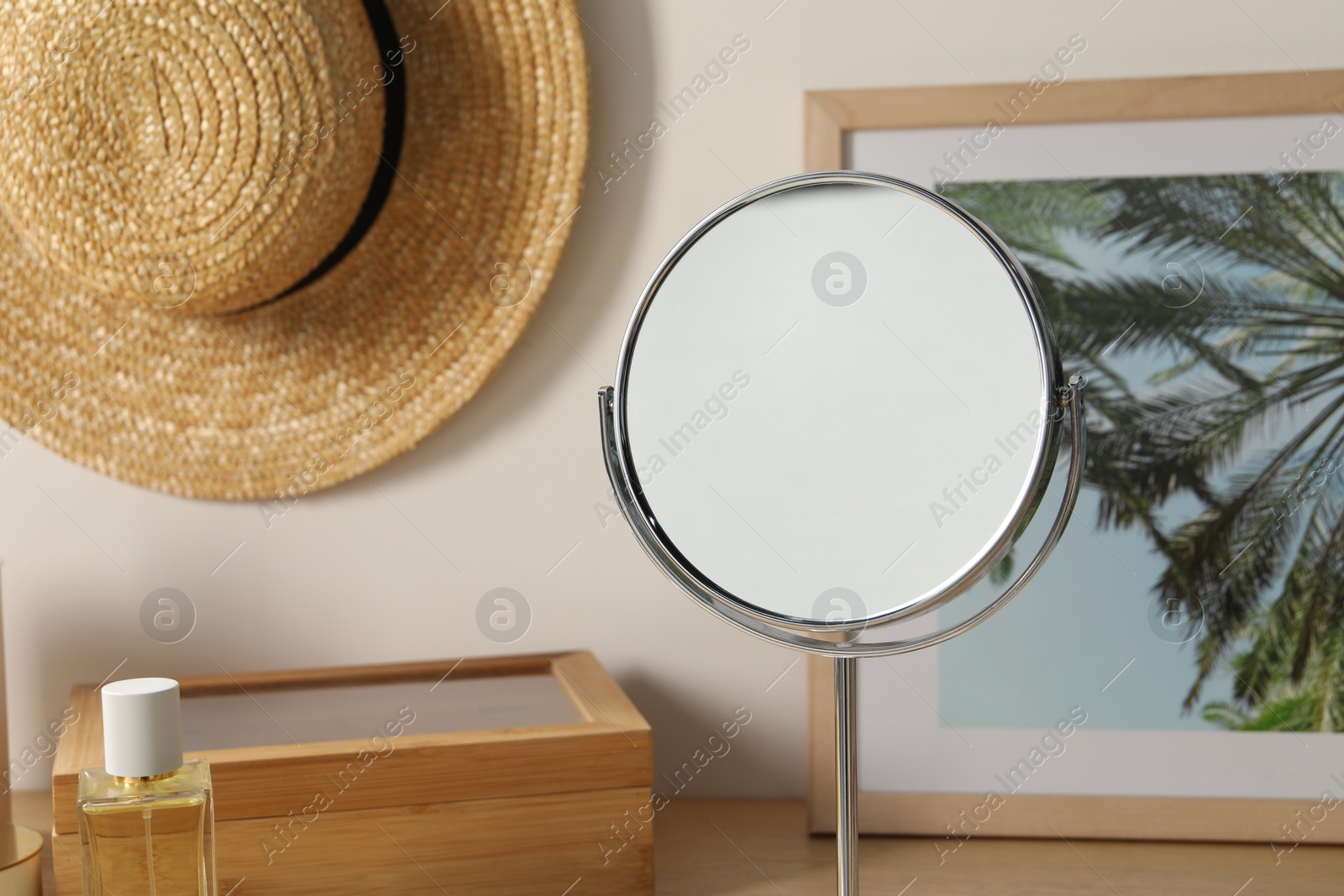 Photo of Mirror, perfume, hat and picture in room