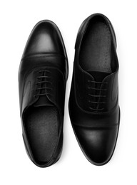 Photo of Pair of black leather men shoes on white background, top view