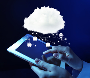 Image of Cloud computing and storage concept. Woman using tablet on dark background, closeup