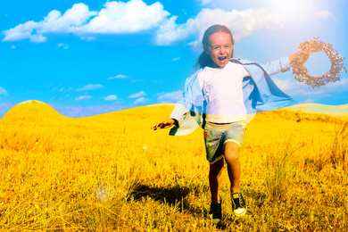 Double exposure of cute little girl with flower wreath running in field and Ukrainian flag 